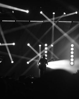 Performer in black-and-white stage beams